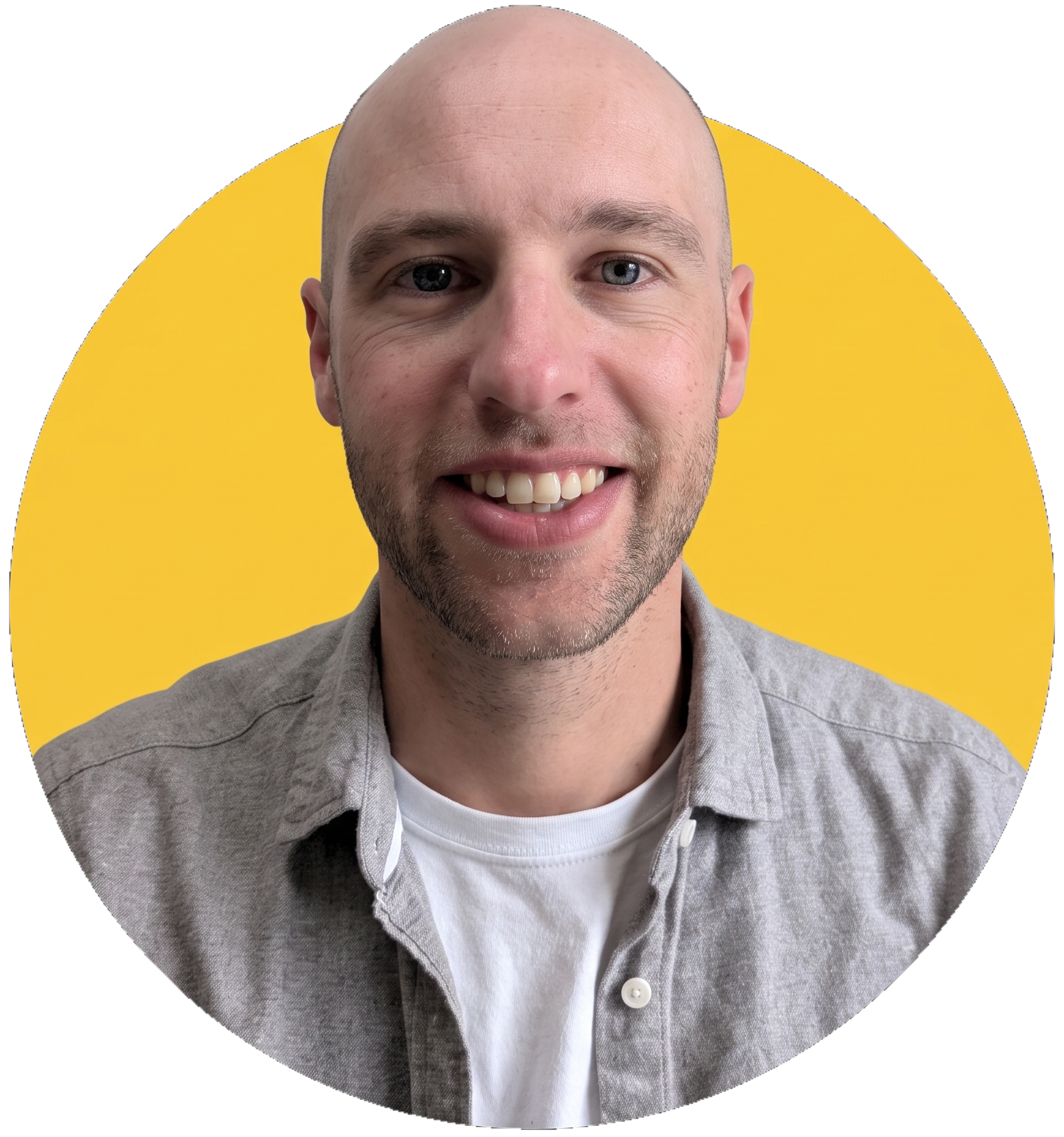 Mike Booth smiling, in a grey shirt against a yellow circle
