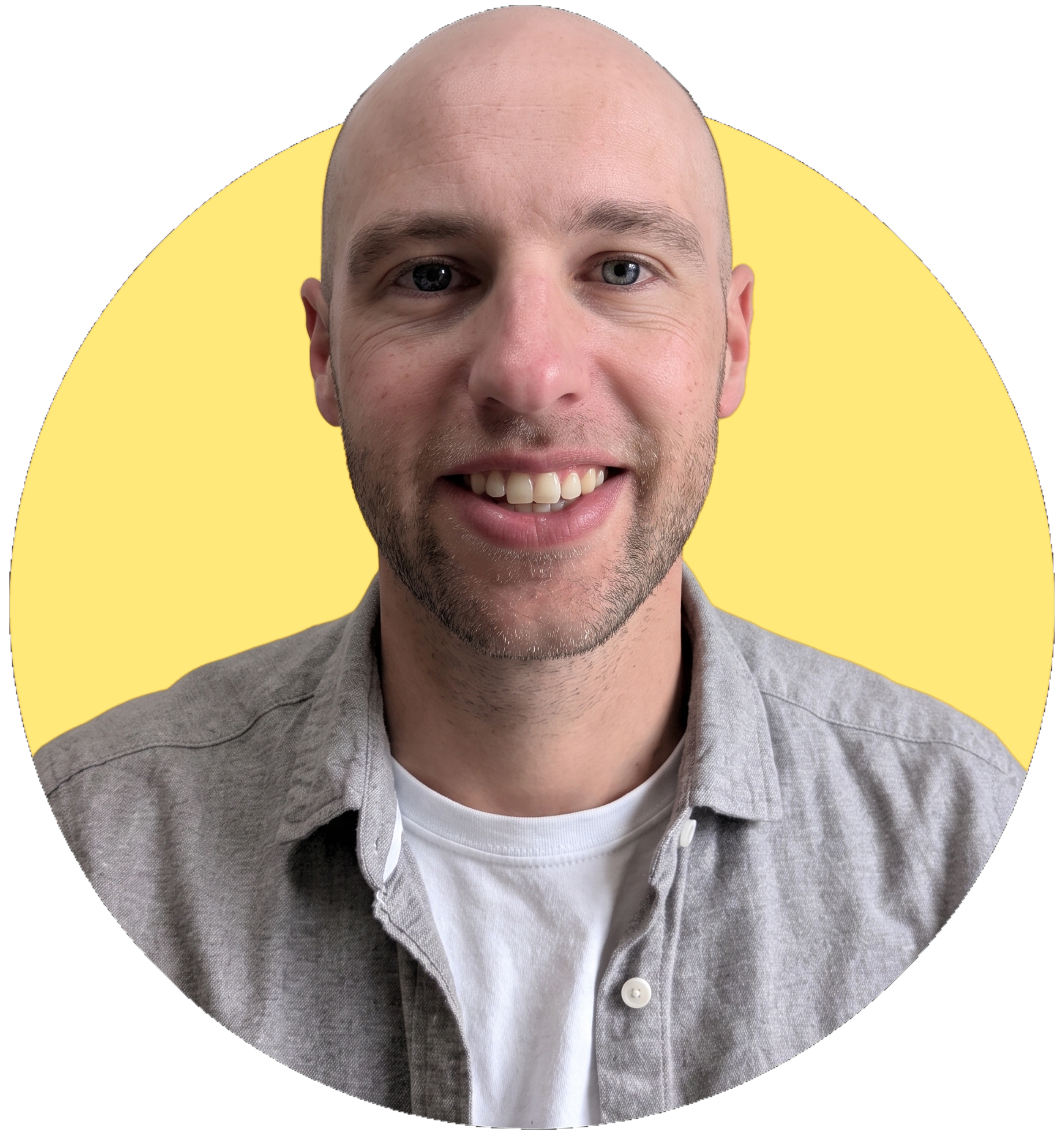 Mike Booth smiling, in a grey shirt against a yellow circle